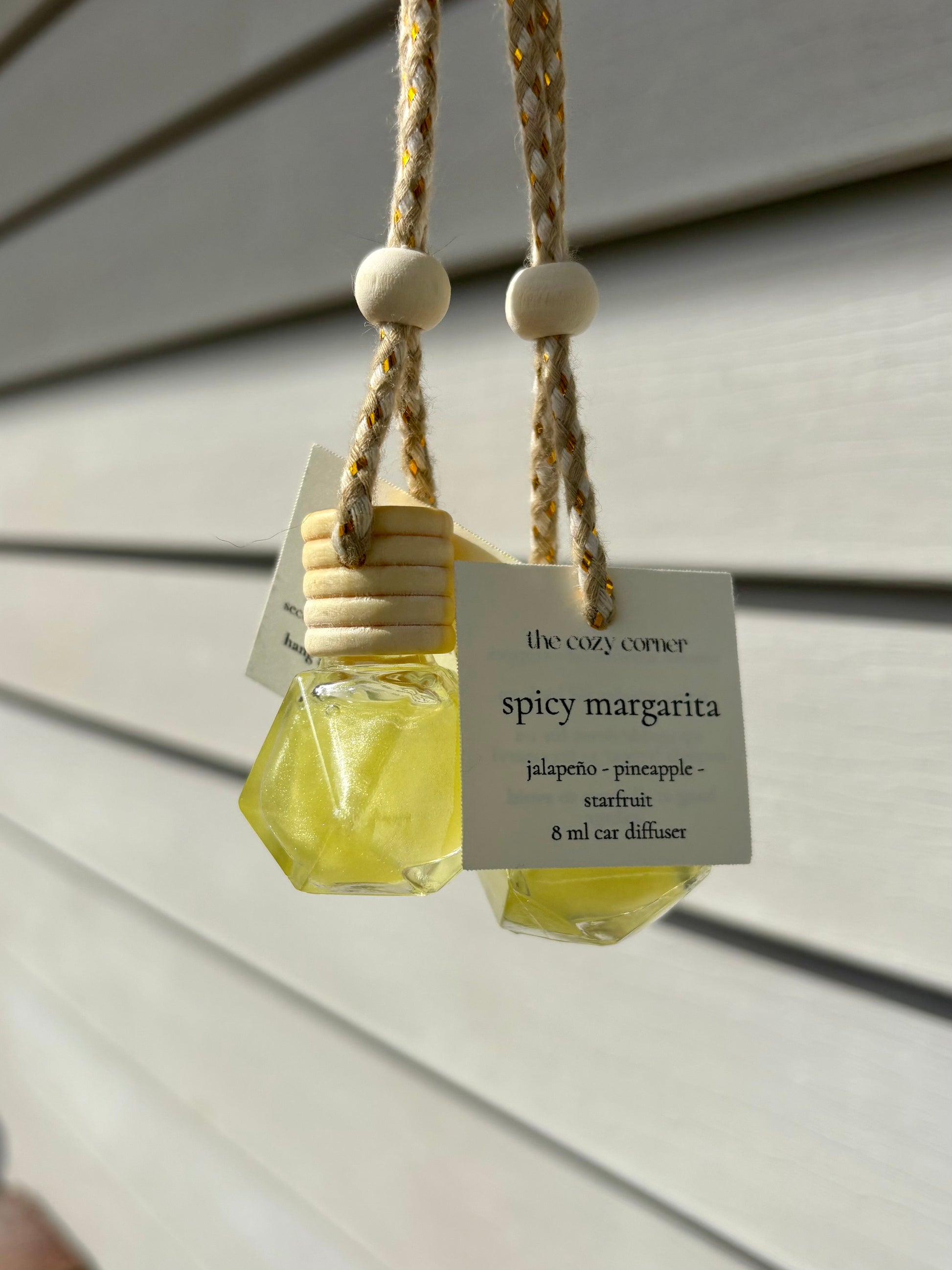 Yellow geometric diffuser with a label on a wooden surface