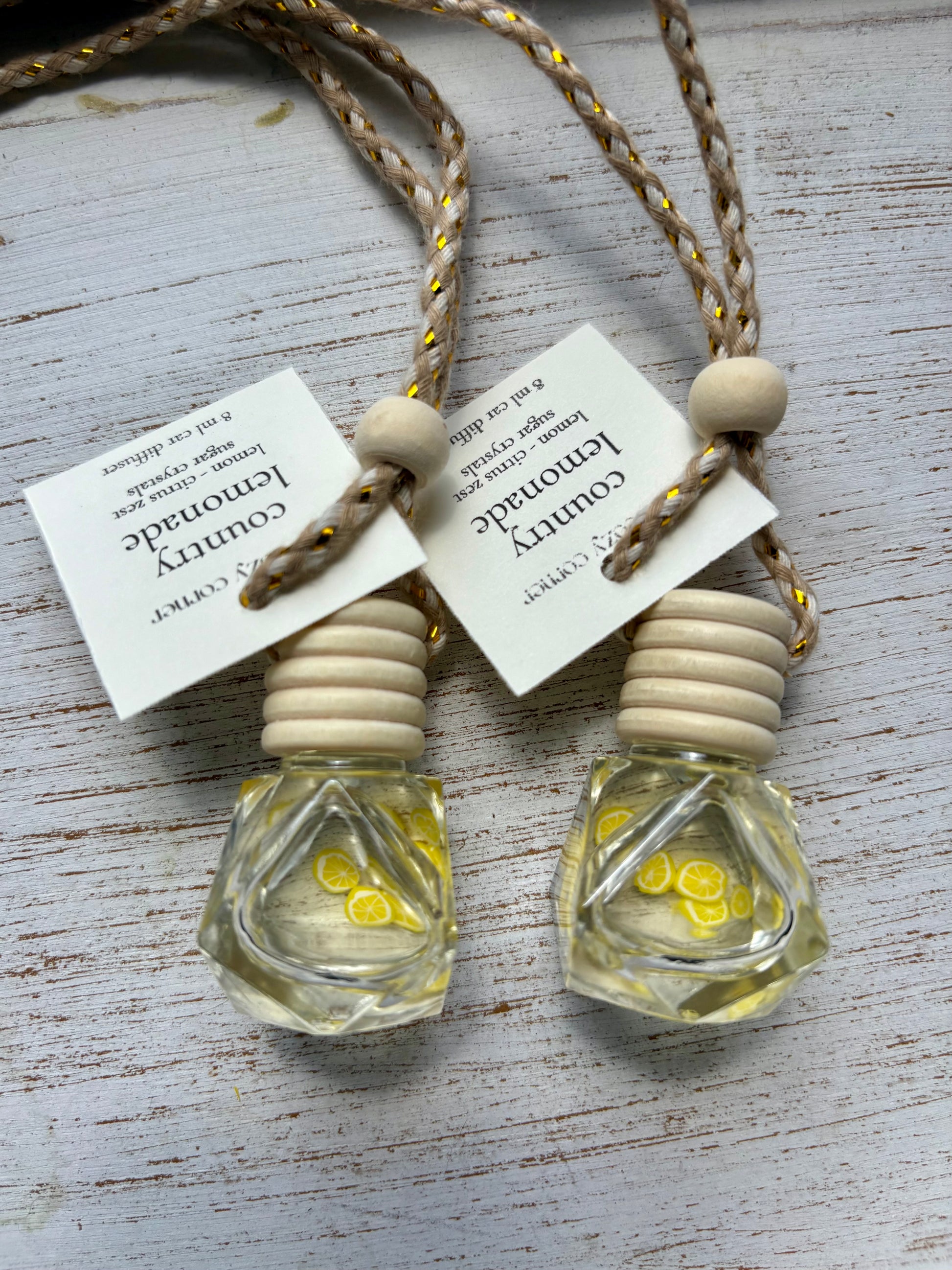 Two small glass bottles with wooden stoppers on a textured surface